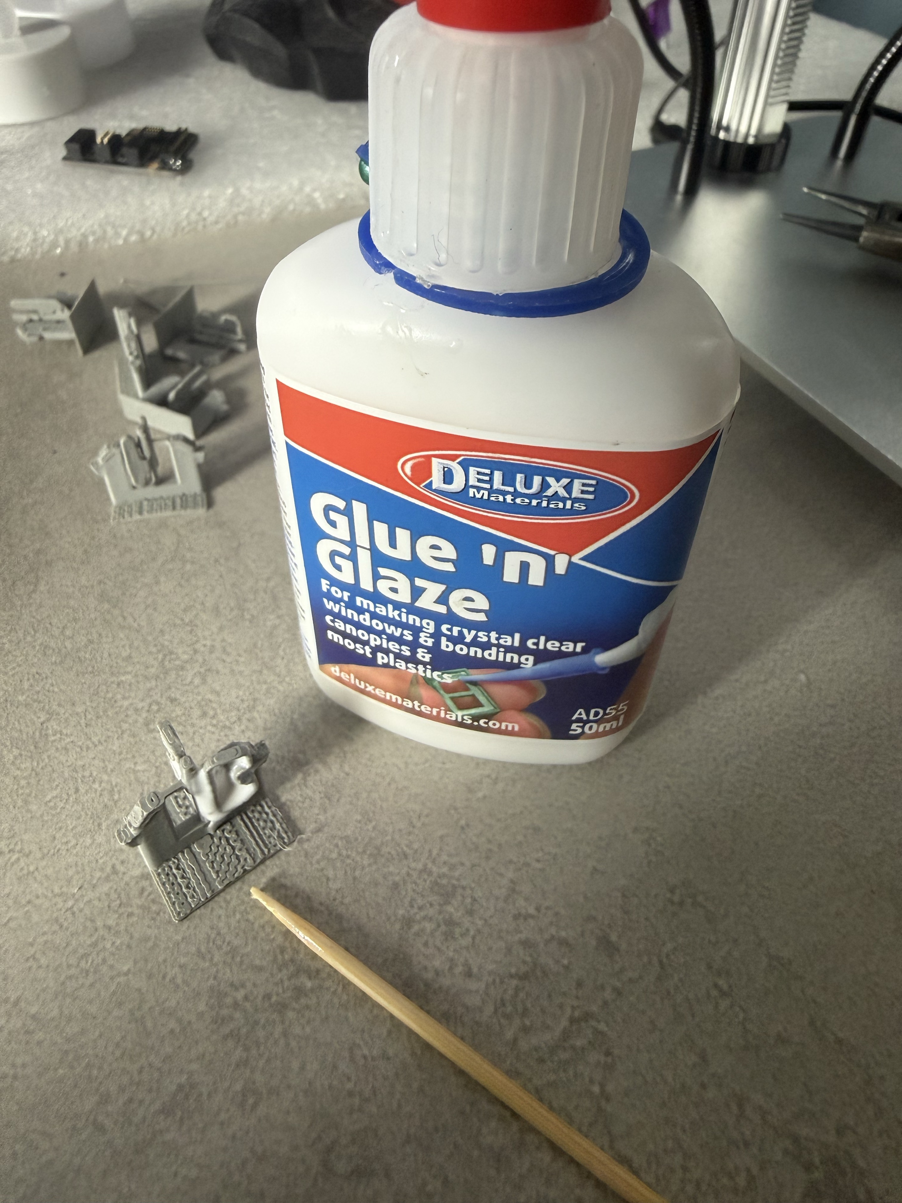 Deluxe Materials Glue ’n’ Glaze bottle, cocktail stick and actual printed ticket gate